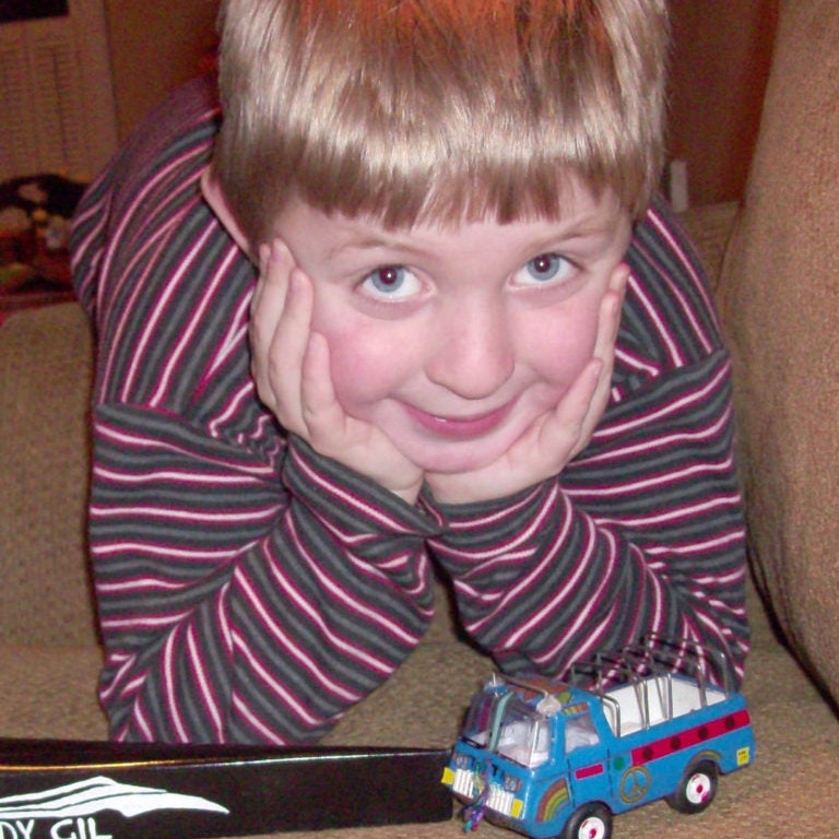 a young boy playing with a toy truck