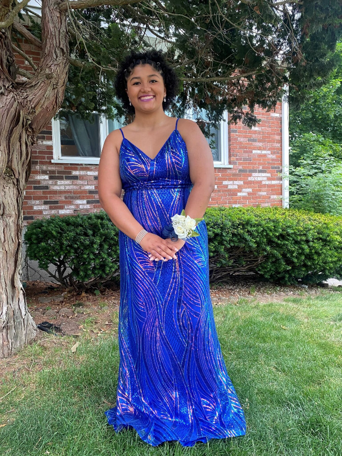 a girl in a blue prom dress posing for pictures