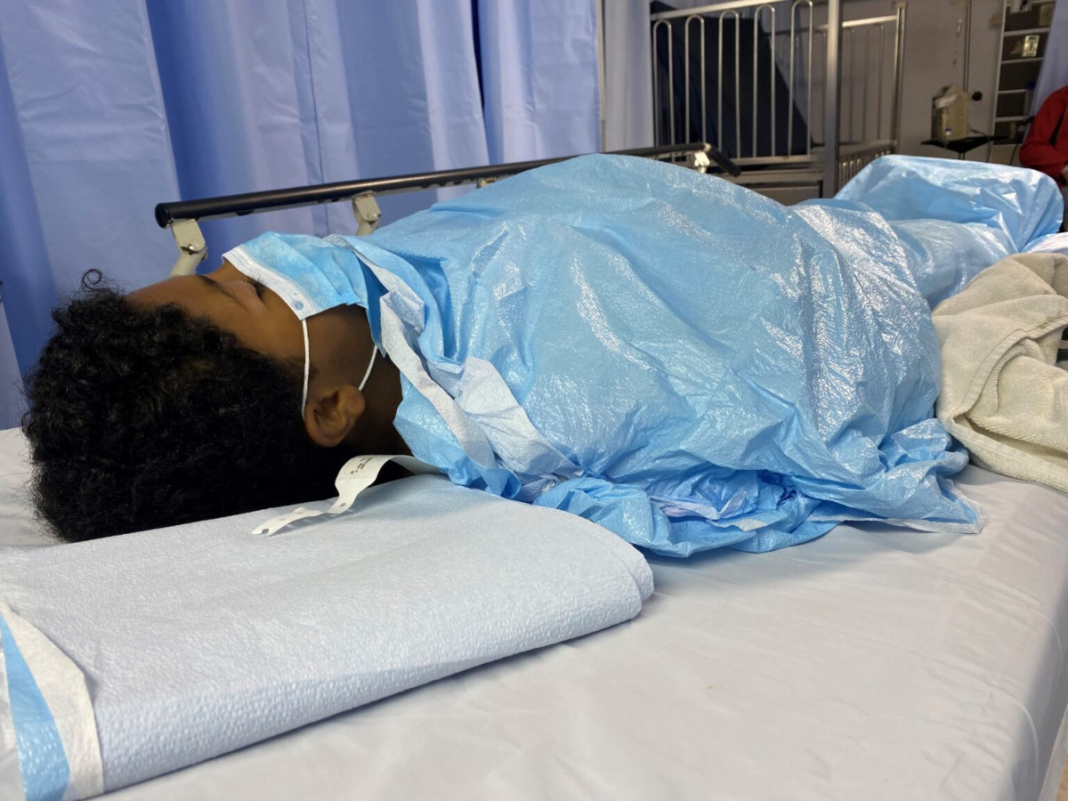 a girl lying on a hospital bed