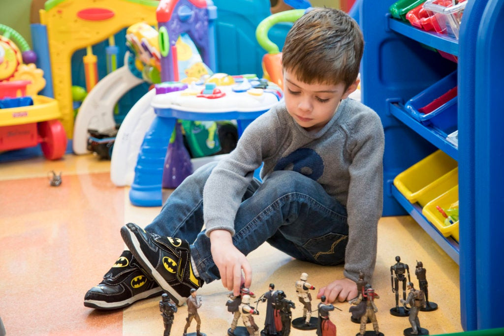 a boy playing with figurines