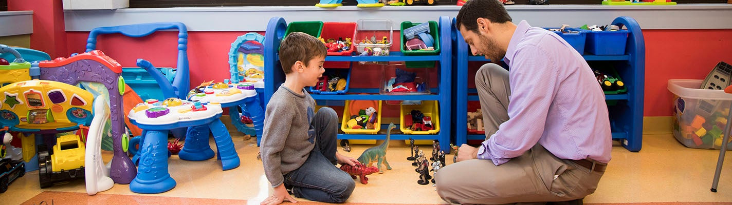 a boy and man playing on the floor