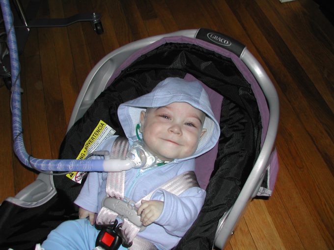a baby boy in a baby carrier