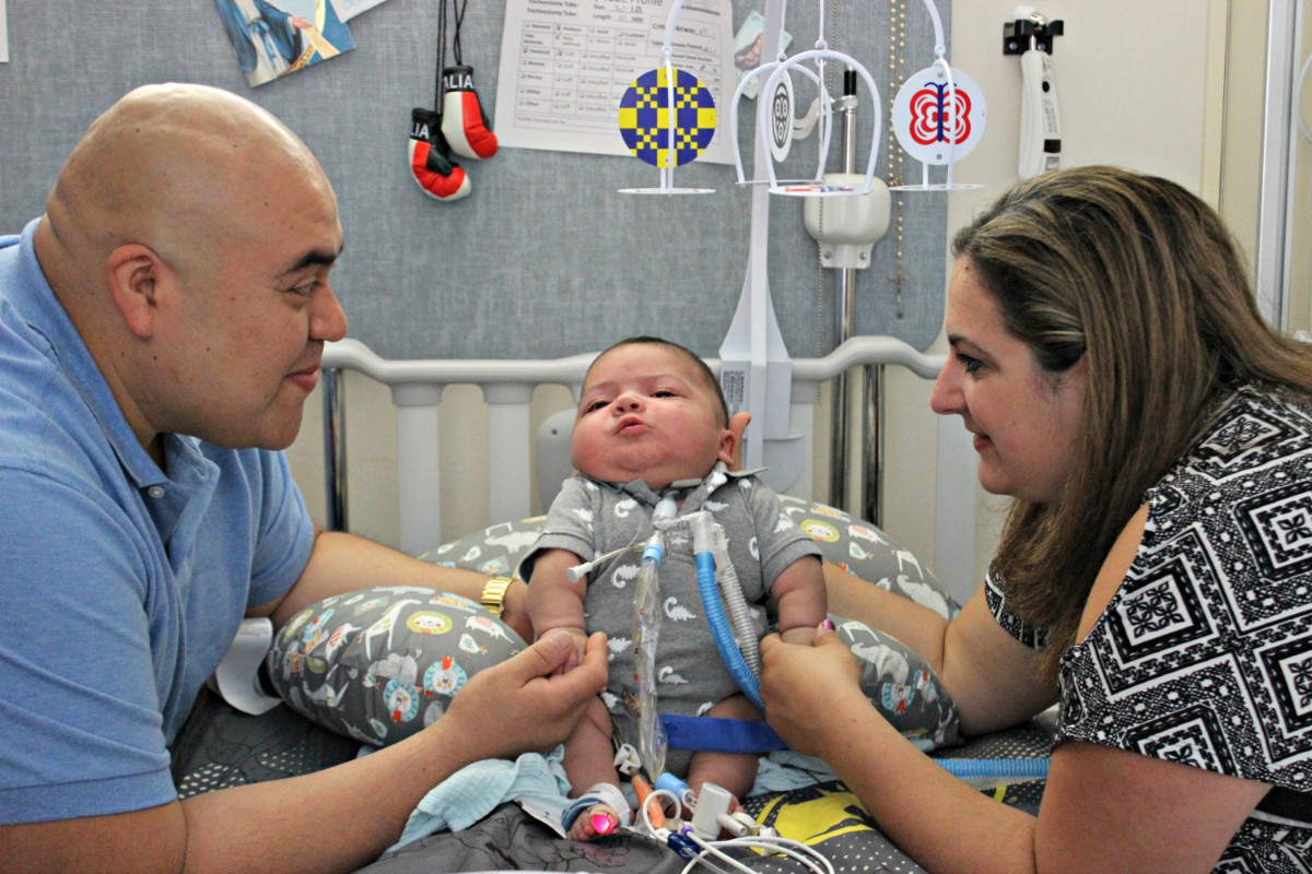 an infant boy and his father and mother