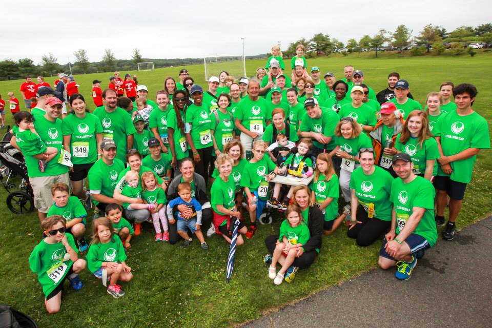 a large group of people in green shirts