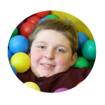 a boy in a ball pit