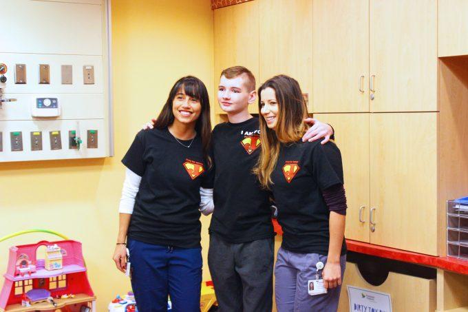 a teenage boy between two medical providers