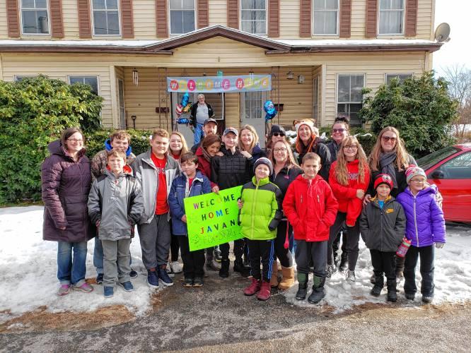 a large group of people with welcome home signs