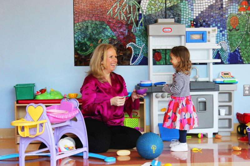 a woman and young girl playing together