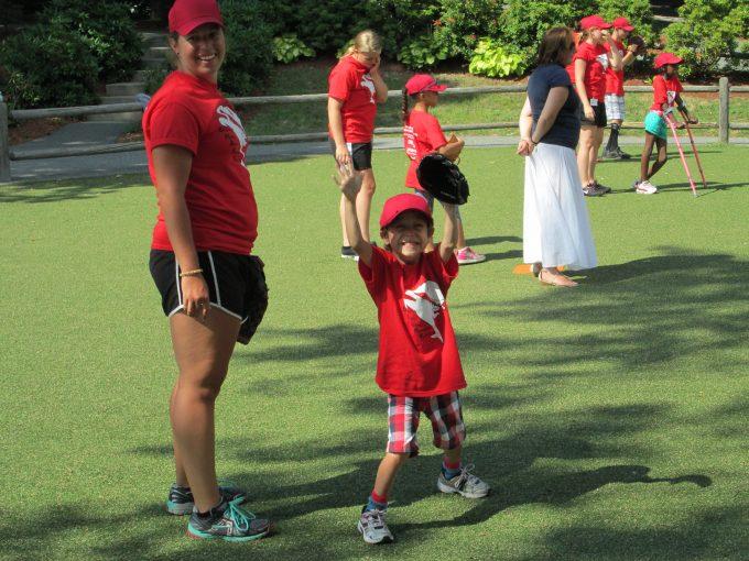 a boy in baseball gear cheering