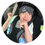 a boy in a car seat