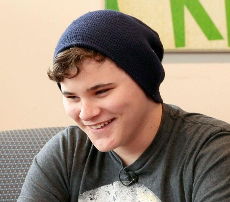 a teen boy in a beanie