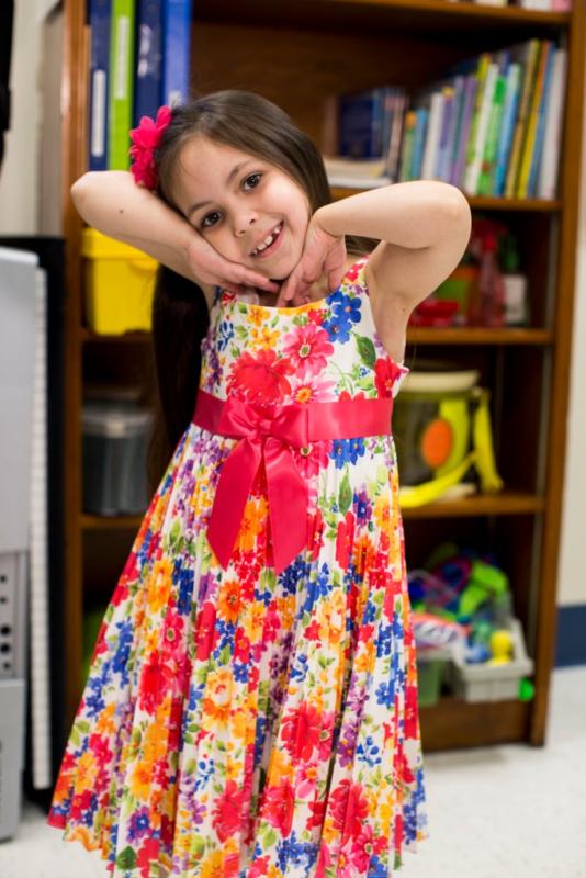 a girl in a bright multicolored dress
